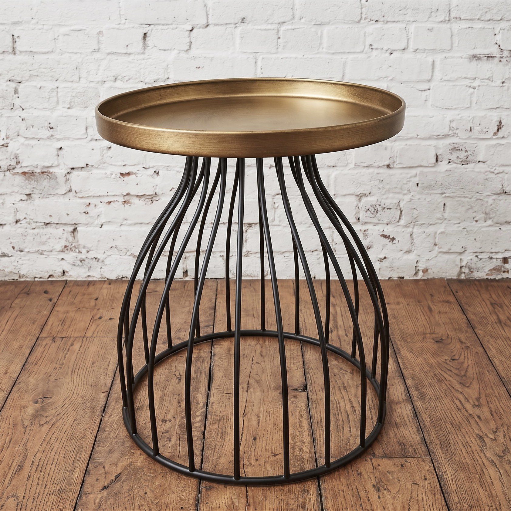 A round black and gold side table with a cage like base - Cambrewood